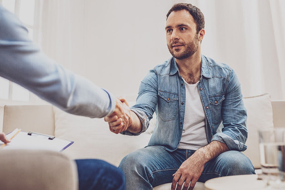 treatment-for-benzodiazepine-addiction Patient shaking hands with counselor after starting benzodiazepine addiction treatment