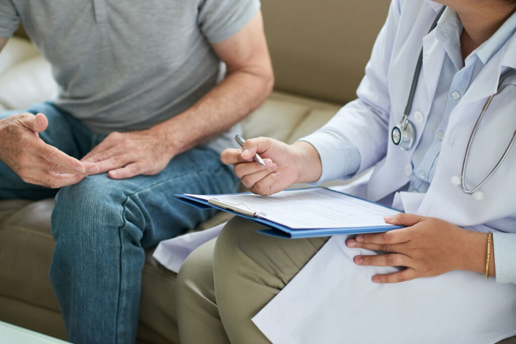 Man consulting with doctor about end-stage alcoholism