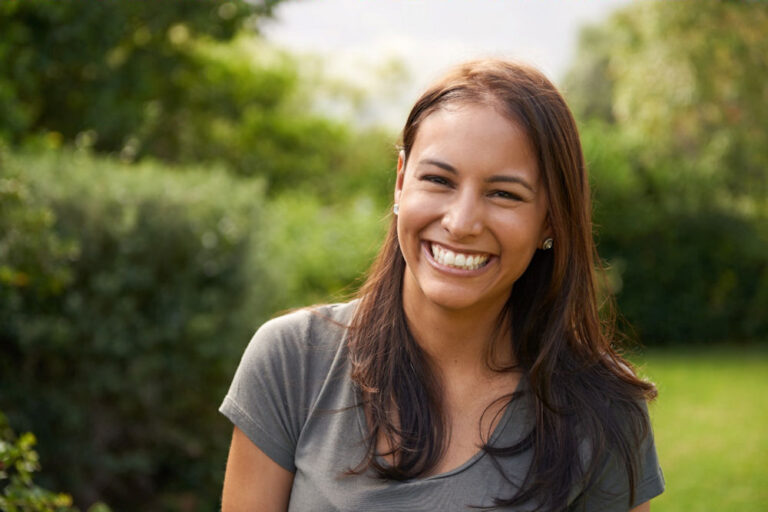 addiction-individual-therapy-westlake-village woman smiling in garden after undergoing individual therapy for addiction