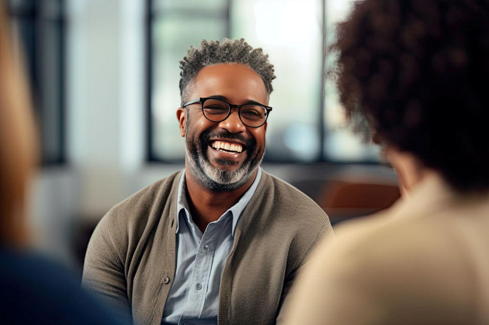 cbt-addiction-westlake-village-ca man laughing during group CBT for addiction treatment