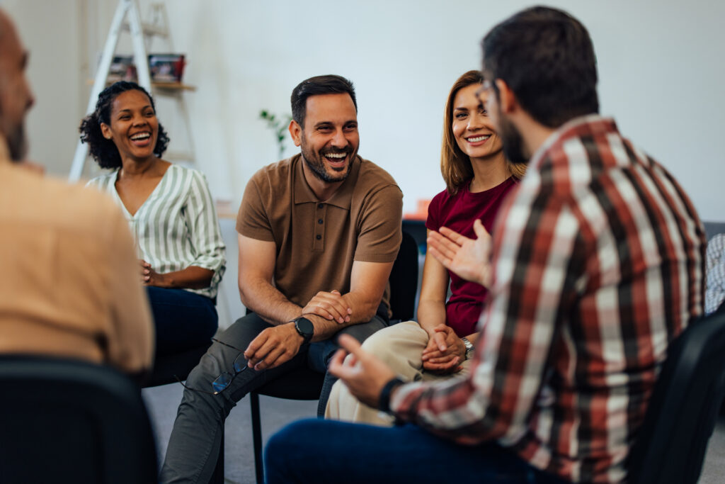 Group of people laughing while talkins about crack versus cocaine.