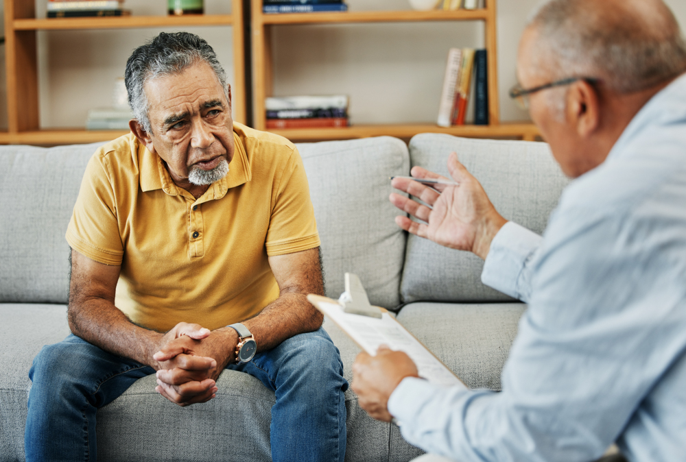 Man speaking with therapist about DBT for addiction therapy.