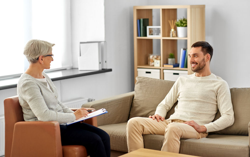 Man looks upset during motivational interviewing therapy.
