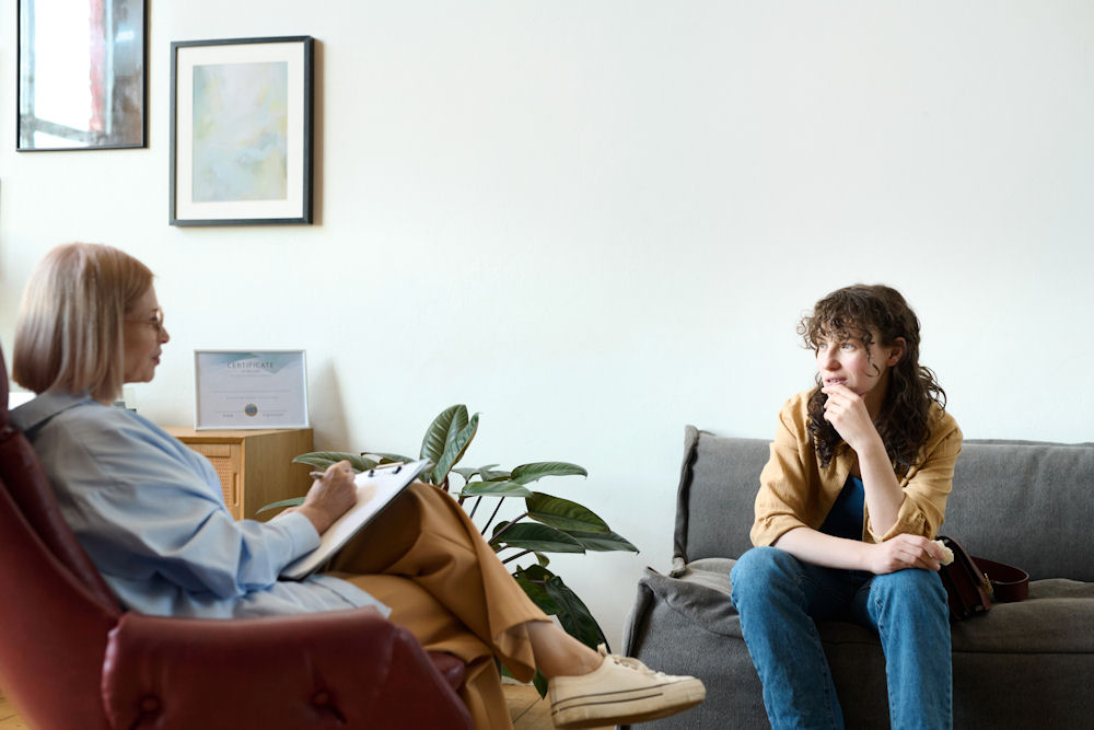 Woman talking to therapist about EMDR therapy for addiction.