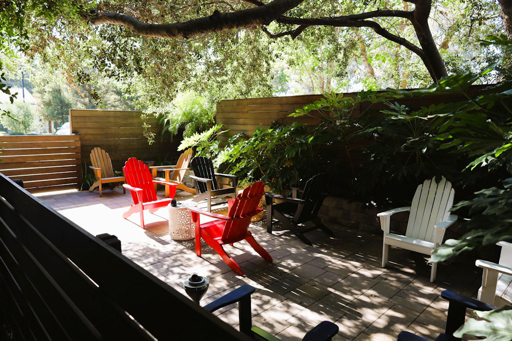 Outdoor patio with Adirondack chairs under shady trees at Westlake Village Recovery Outdoor patio with Adirondack chairs under shady trees at Westlake Village Recovery